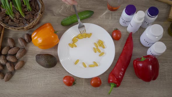 Top View Plate with Antioxidant Vitamins and Fork Mixing Pills