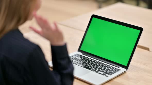 Rear View of Businesswoman Using Laptop with Chroma Screen