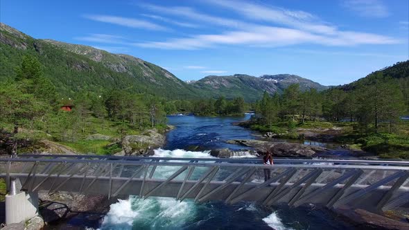 Young girl watching waterfall Likholefossen