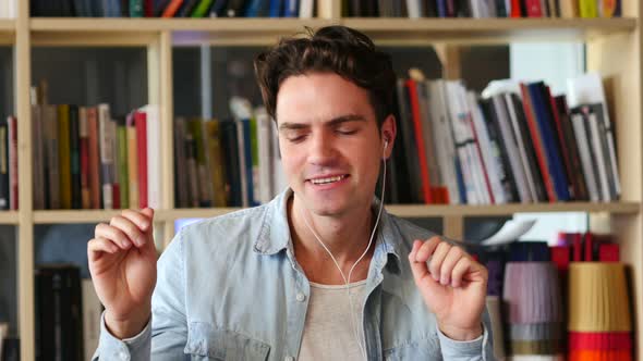 Young Man Listening Music and Dancing