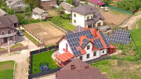 Aerial view of a house in residential area with solar panels on the roof