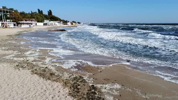 Aerial Drone View Flight Over Waves That Roll Onto the Sandy Shore