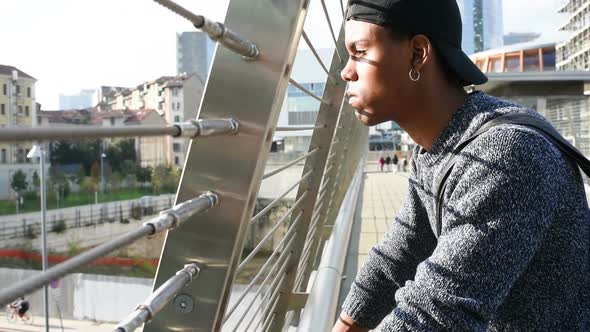 Young handsome american african man outdoor in the city, looking over serious