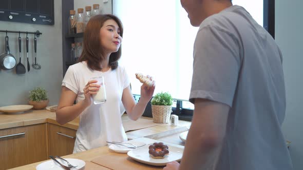 asian couple are feeding each other cooking food in the kitchen  have romantic time.