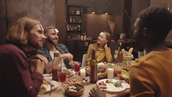 Happy Dinner Guests Playing Game