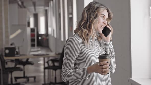 Smiling Professional Woman Making a Friendly Phone Call Talking To Friend While Coffee Break Irrl