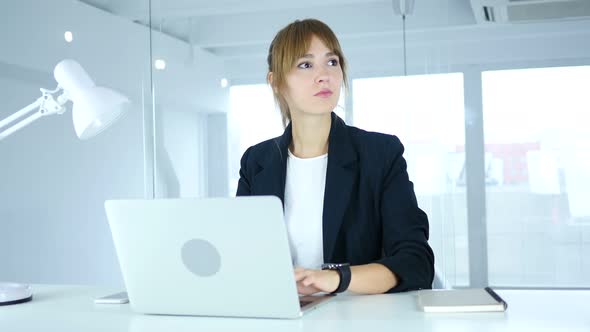 Woman Waiting at Work, Watching Time on smartwatch