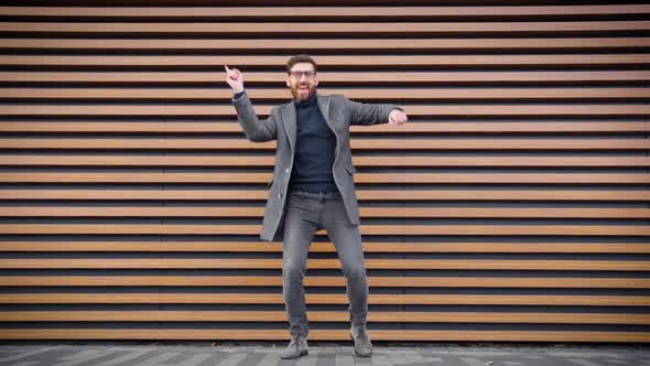 Happy Overjoyed Businessman Dancing Alone on Street Celebrating Business Success