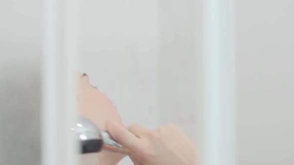 Lovely Caucasian Woman Taking a Shower at Home or at the Hotel