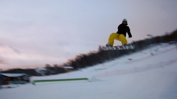 Snowboarder Jumping on the Snowboard Park