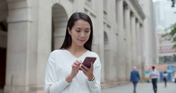 Woman look at mobile phone in Hong Kong