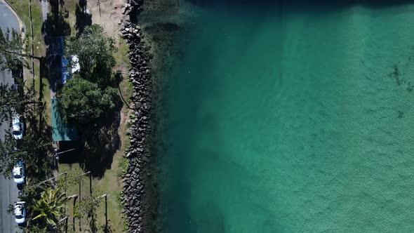 Scenic high view over a crystal clear creek at a popular family holiday park and fishing spot. Movin