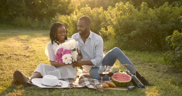 Black Couple with Flowers on a Summer Picnic
