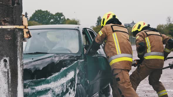 Firefighters Cutting Car Door Open at Scene of Car Accident. Slow Motion