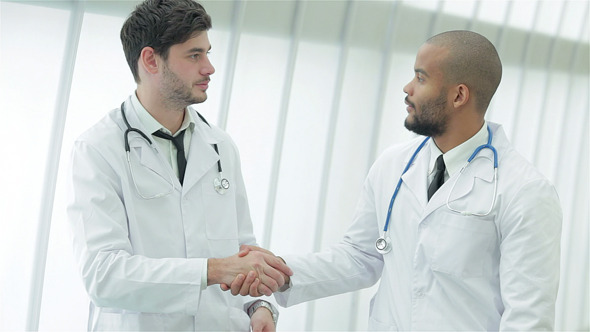 Two Young Doctors Do Handshake