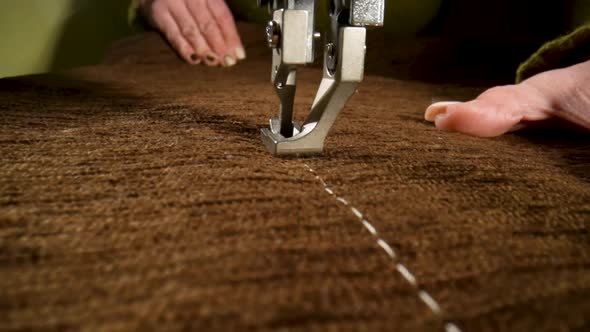 Seamstress Sews Woolen Fabric on Sewing Machine Advances Fabric with His Fingers