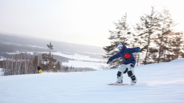 Snowboarder Riding Down the Hill