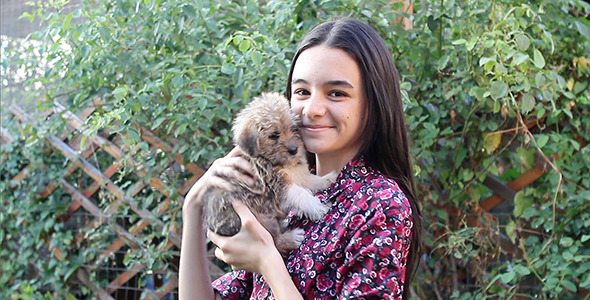 Teenage Girl and Puppy in the Garden
