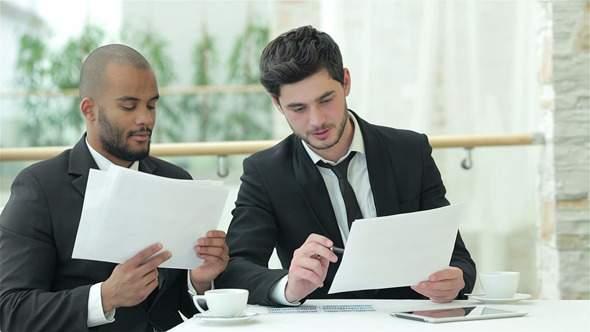 Businessmen Reading Documents