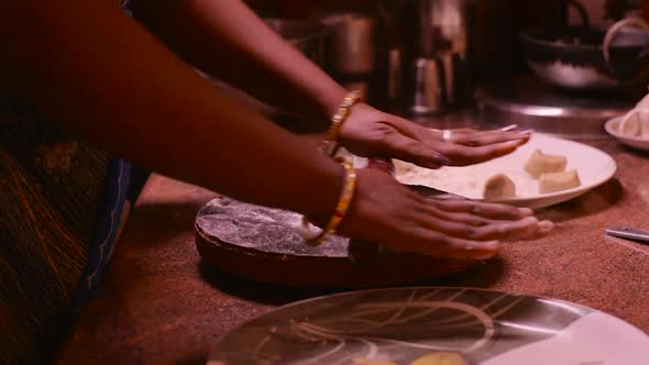 Women Preparing Chapatis in kitchen