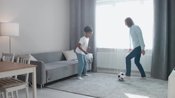 Father and African Daughter on Selfisolation They Playing with a Soccer Ball in the Living Room