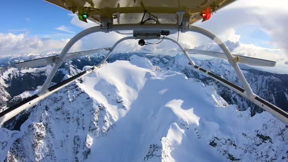 Winter Expedition Deep Into Mountainous Backcountry Flying Helicopter Reverse Skids View