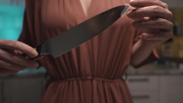Female holding a new sharp polished steel knife