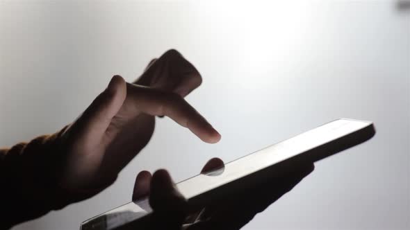 Person's hands using a tablet