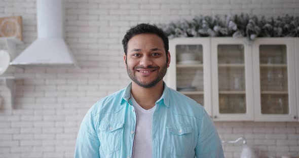 Latin American Man Looking at Camera at Kitchen in the Morning