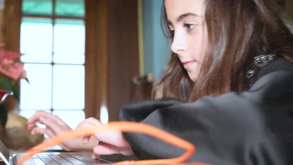 Young Girl Using Laptop at Home