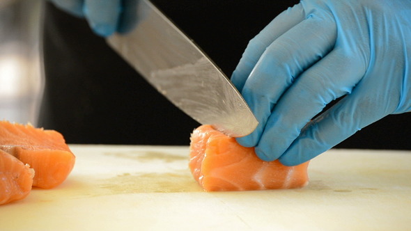 Professional Chef Hands Cooking Salmon