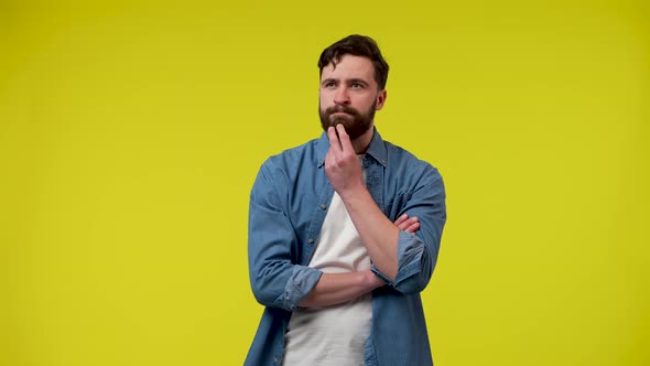 Portrait of a Man Thinking Intently Putting His Hand on His Chin Happily Raising His Index Finger an