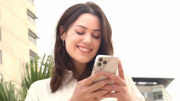 Latin Young Business Woman Chatting with the Mobile Phone