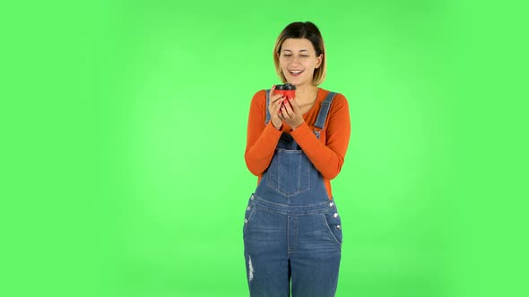 Cheerful Young Woman Enjoying Coffee on Green Screen