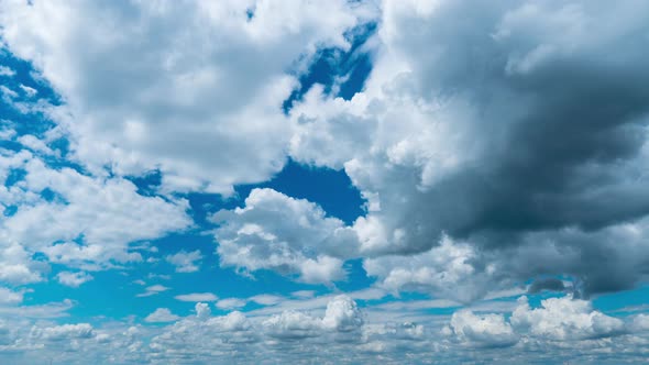 White Fluffy Clouds Slowly Float Through the Blue Daytime Sky Timelapse