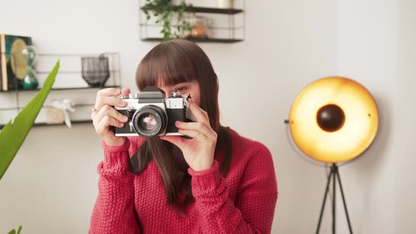 Young Caucasian Brunette Freelance Photography Artist Takes Photo with Her Professional Camera