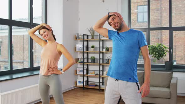 Happy Couple Exercising at Home