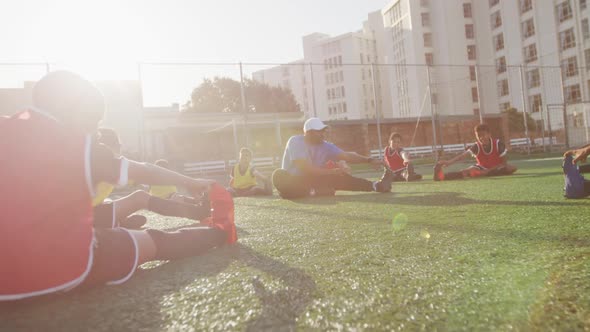 Soccer kids exercising in a sunny day