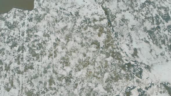 Flycam Films Unusual Ice Surface of Large Grey Frozen River