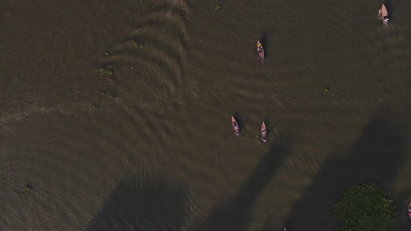 Top down view of canoes paddling on the Buriganga River in Bangladesh, slow motion
