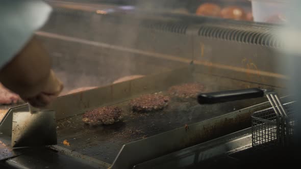 Chief Cook Preparing Fresh Burger in the Kitchen Grill