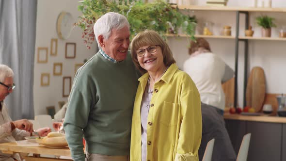 Portrait of Happy Elderly Couple at Home Dinner Party