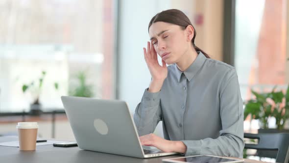 Young Latin Woman with Headache Working on Laptop