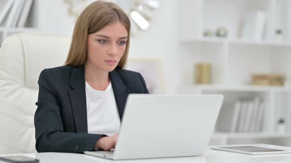 Businesswoman Shocked By Results on Laptop 