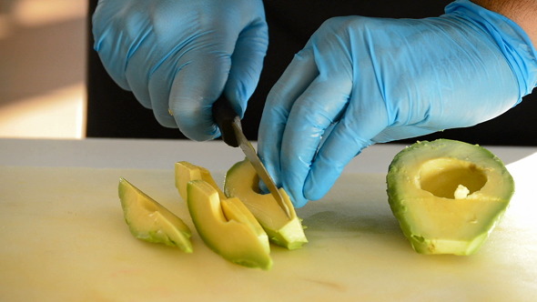 Professional Chef Hands Cooking an Avocado Fruit