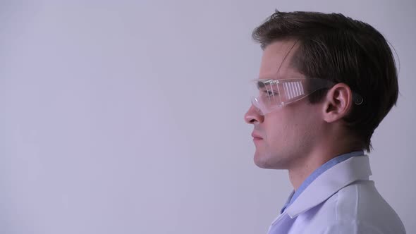 Profile View of Young Handsome Man Doctor Wearing Protective Glasses