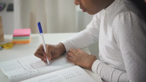 Hispanic Child Is Doing Math Task in Notebook for Preparing To New Lesson at Home