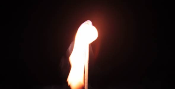 A Burning Match On A Black Background