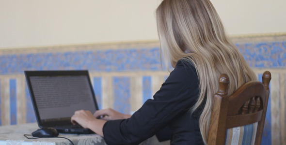 Girl in Cafe With Laptop
