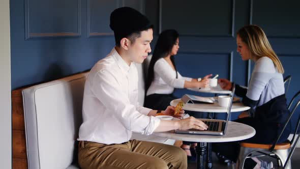 Asian Businessman using laptop in cafeteria at office 4k